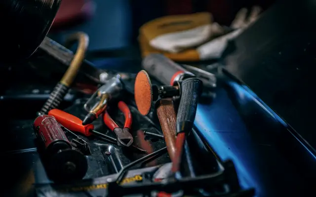 Toolbox full of pliers, cutters and worn hand tools