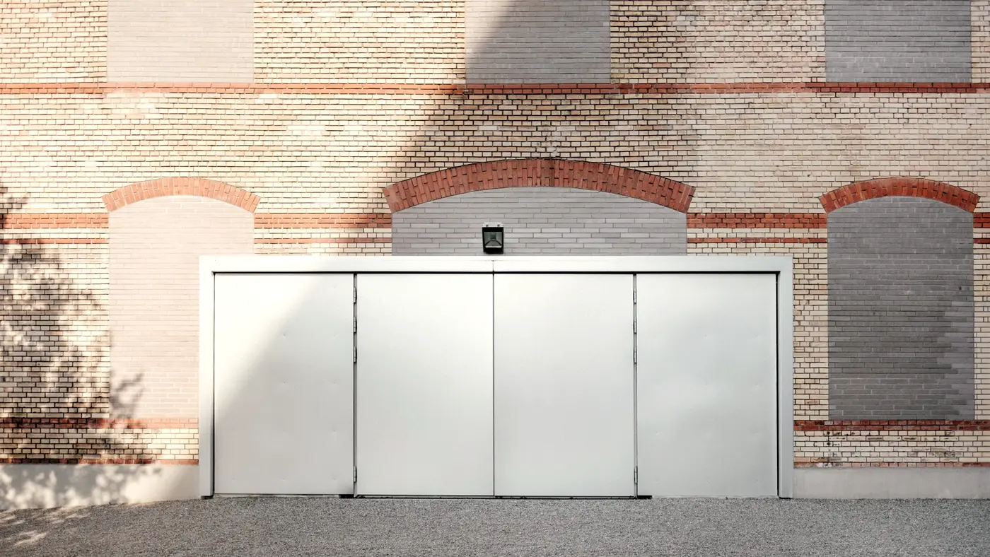 Closed steel sliding door set in a brick industrial building