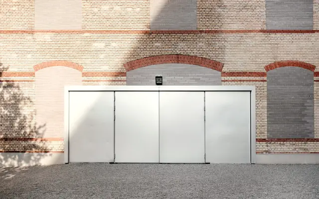 Closed steel sliding door set in a brick industrial building