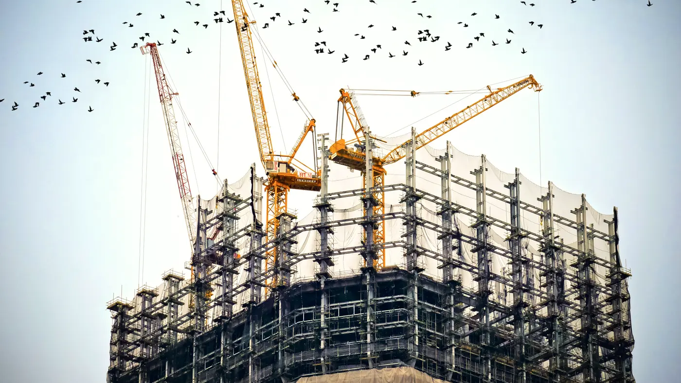 Tower cranes above a building under construction