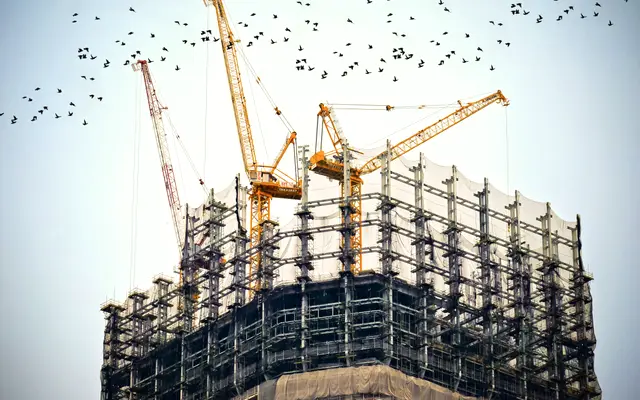 Tower cranes above a building under construction