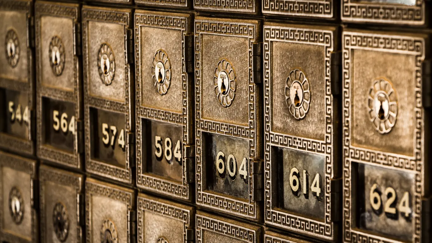 Rows of numbered vintage brass post office boxes