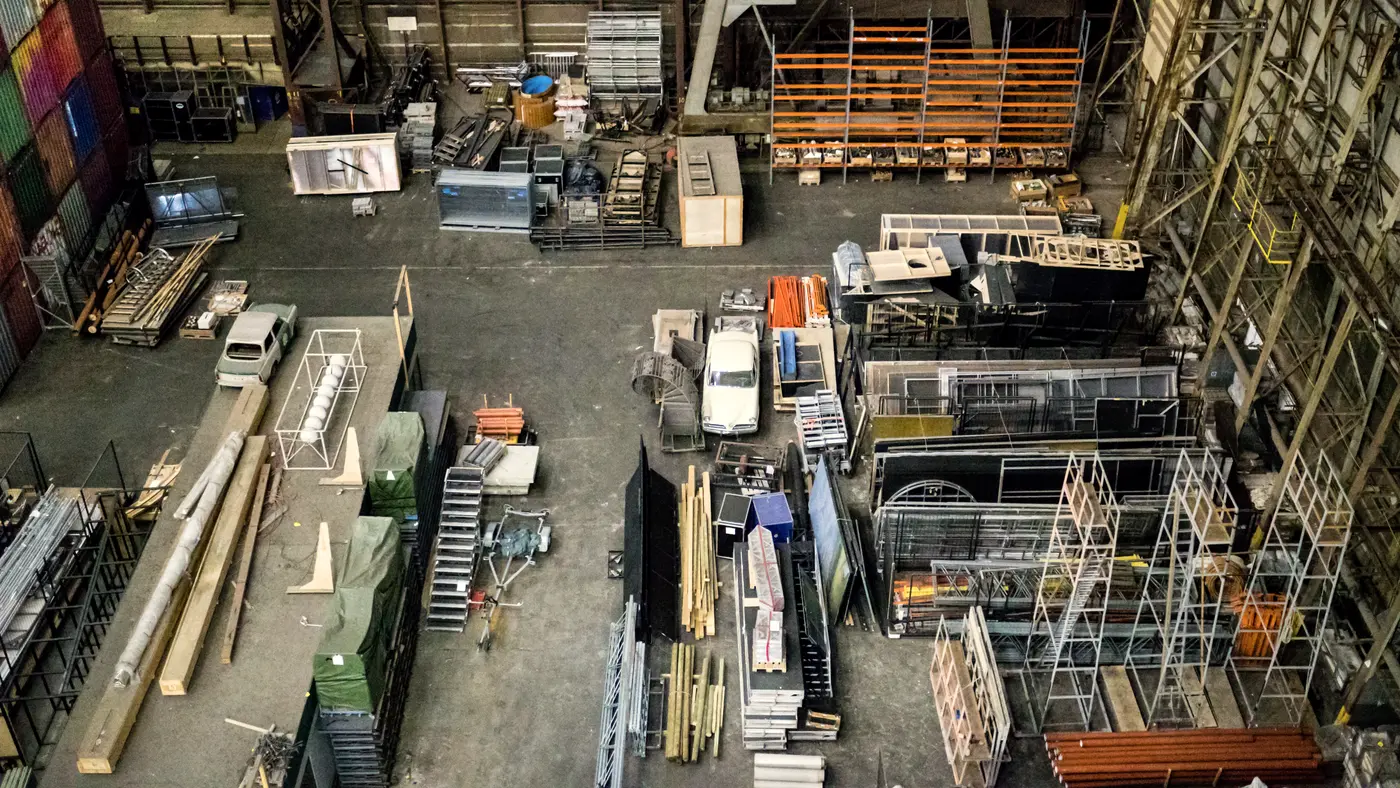 Overhead view of a busy industrial workshop floor with materials