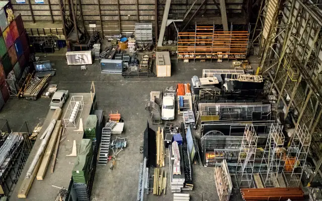 Overhead view of a busy industrial workshop floor with materials