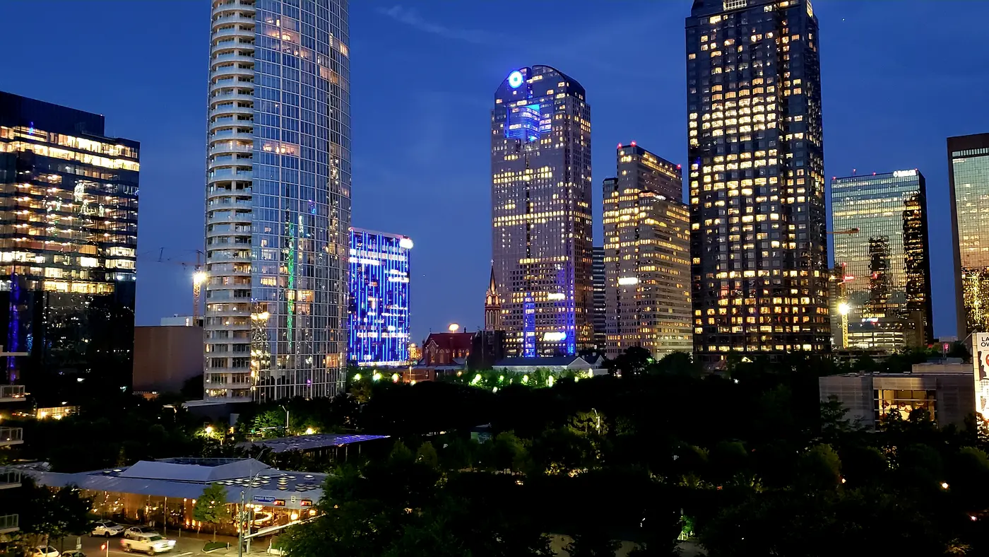 Uptown Dallas glass towers illuminated at dusk