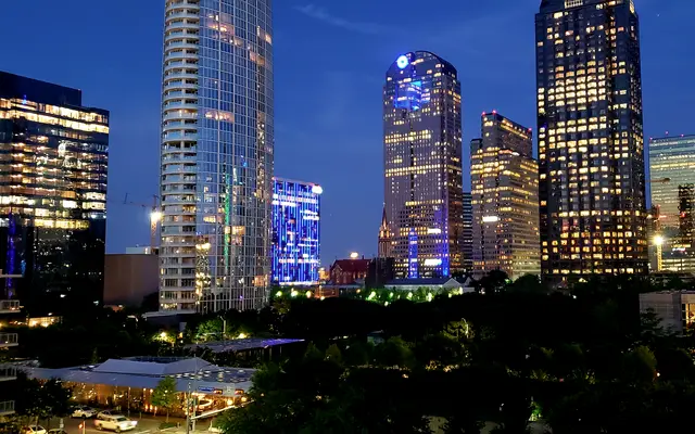Uptown Dallas glass towers illuminated at dusk