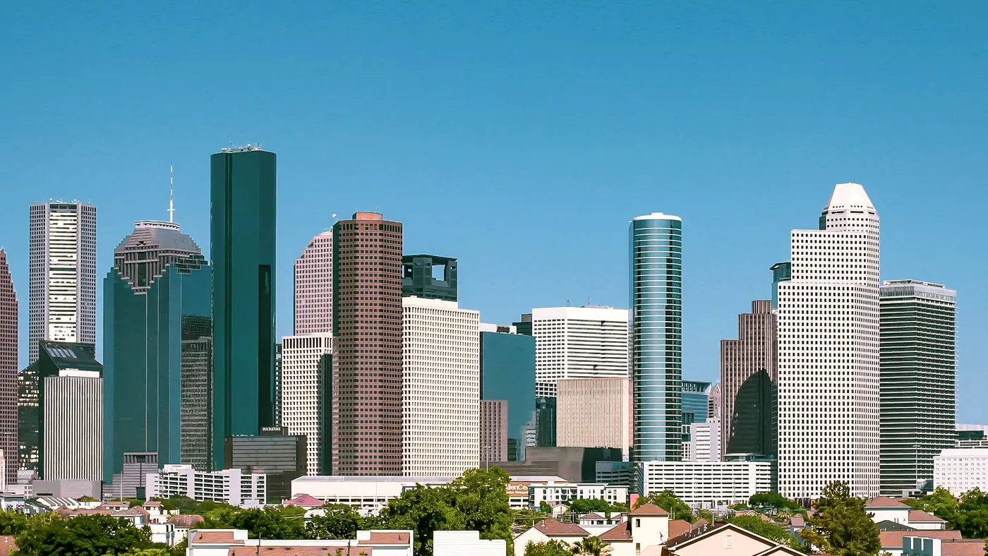 Wide view of the Houston skyline under a clear blue sky