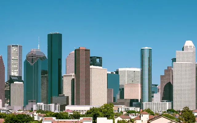 Wide view of the Houston skyline under a clear blue sky